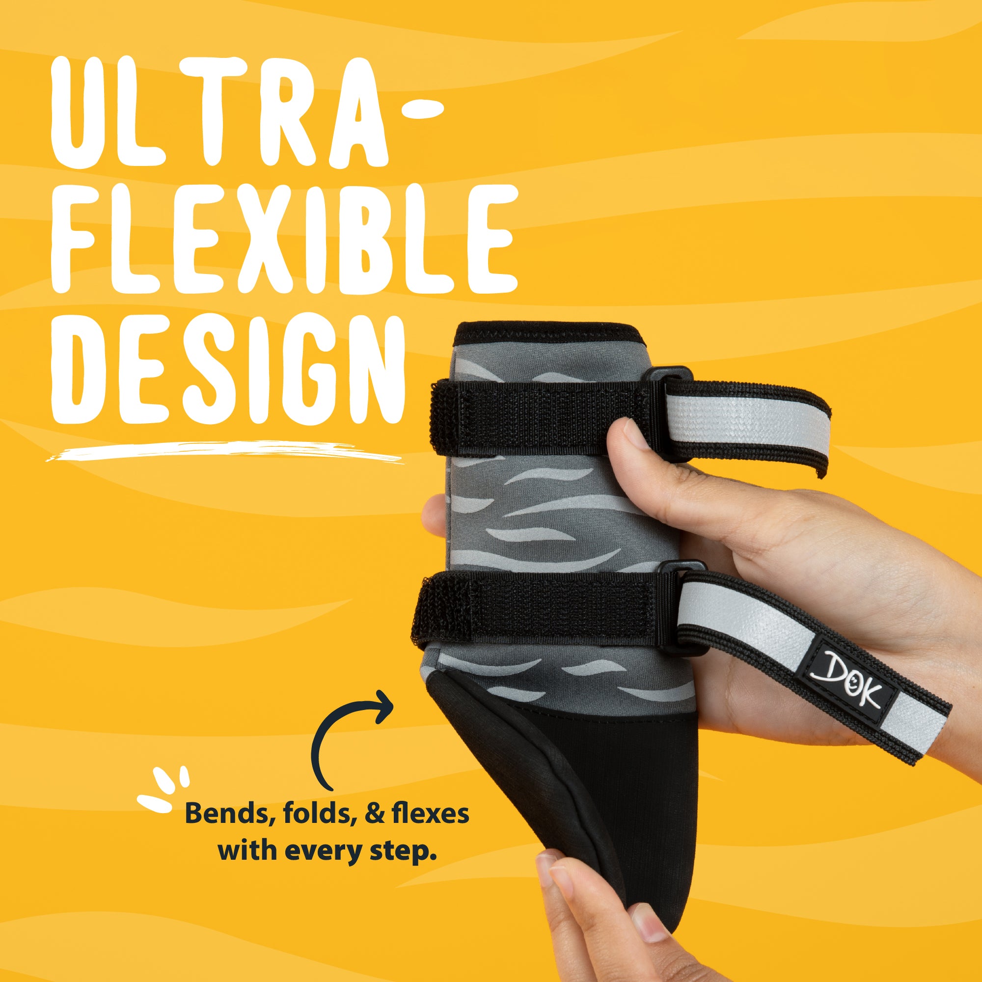 A dog bootie with a gray and black tiger pattern and black straps, held by hands against a bright yellow background with text highlighting its flexible design.